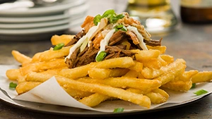 Ore Ida French Fry Seoul Fries Recipe sprinkled with Korean spices in an appetizer smothered in tender shredded beef, spicy kimchi, mayo and green onions.